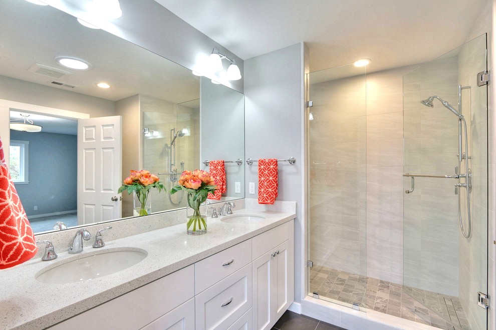 Example of a trendy master porcelain tile and white tile ceramic tile alcove shower design in San Francisco with shaker cabinets, white cabinets, gray walls, an undermount sink and recycled glass countertops