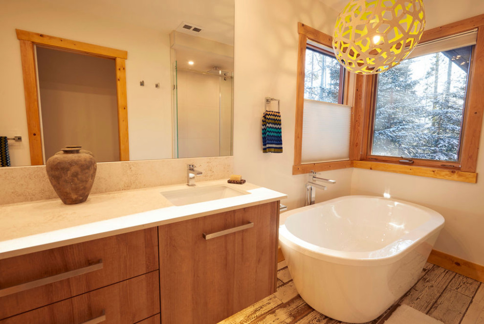 Свежая идея для дизайна: главная ванная комната среднего размера в стиле модернизм с светлыми деревянными фасадами, отдельно стоящей ванной, угловым душем, раздельным унитазом, полом из керамогранита, врезной раковиной, душем с раздвижными дверями, сиденьем для душа, тумбой под две раковины и подвесной тумбой - отличное фото интерьера