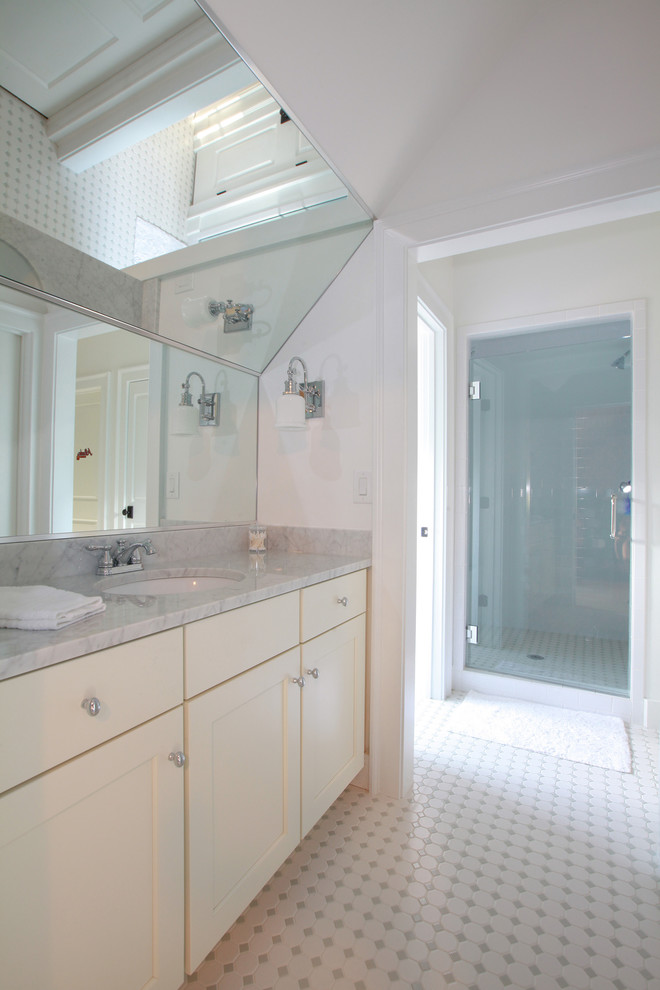 This is an example of a classic family bathroom in Atlanta with a submerged sink, white cabinets, marble worktops, a freestanding bath and white walls.