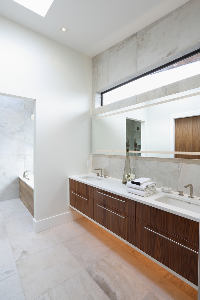 This is an example of a large contemporary ensuite bathroom in Vancouver with a submerged sink, flat-panel cabinets, medium wood cabinets, an alcove bath, an alcove shower, a one-piece toilet, grey tiles, porcelain tiles, white walls and ceramic flooring.
