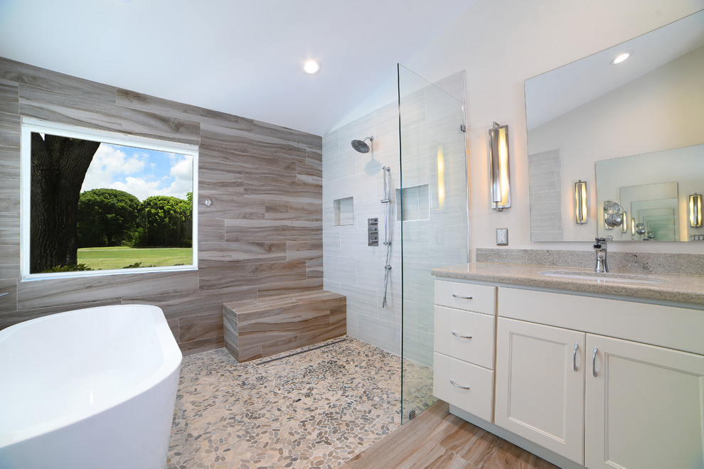 Bathroom - large transitional master porcelain tile porcelain tile and brown floor bathroom idea in Miami with recessed-panel cabinets, white cabinets, a one-piece toilet, beige walls, an undermount sink and granite countertops