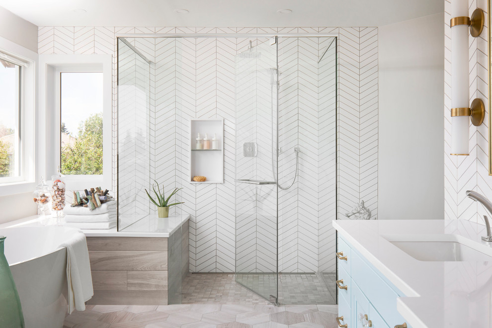 Inspiration for a large transitional master porcelain tile gray floor bathroom remodel in Calgary with recessed-panel cabinets, blue cabinets, white walls, an undermount sink, white countertops, quartz countertops, a hinged shower door and a niche