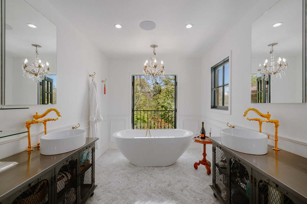 Photo of a large mediterranean ensuite bathroom in Los Angeles with open cabinets, a freestanding bath, white walls and a vessel sink.