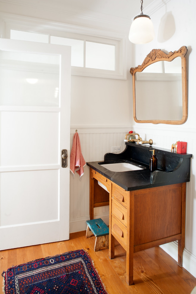 Bathroom - mid-sized country 3/4 medium tone wood floor bathroom idea in Los Angeles with an undermount sink, furniture-like cabinets, medium tone wood cabinets, soapstone countertops and white walls
