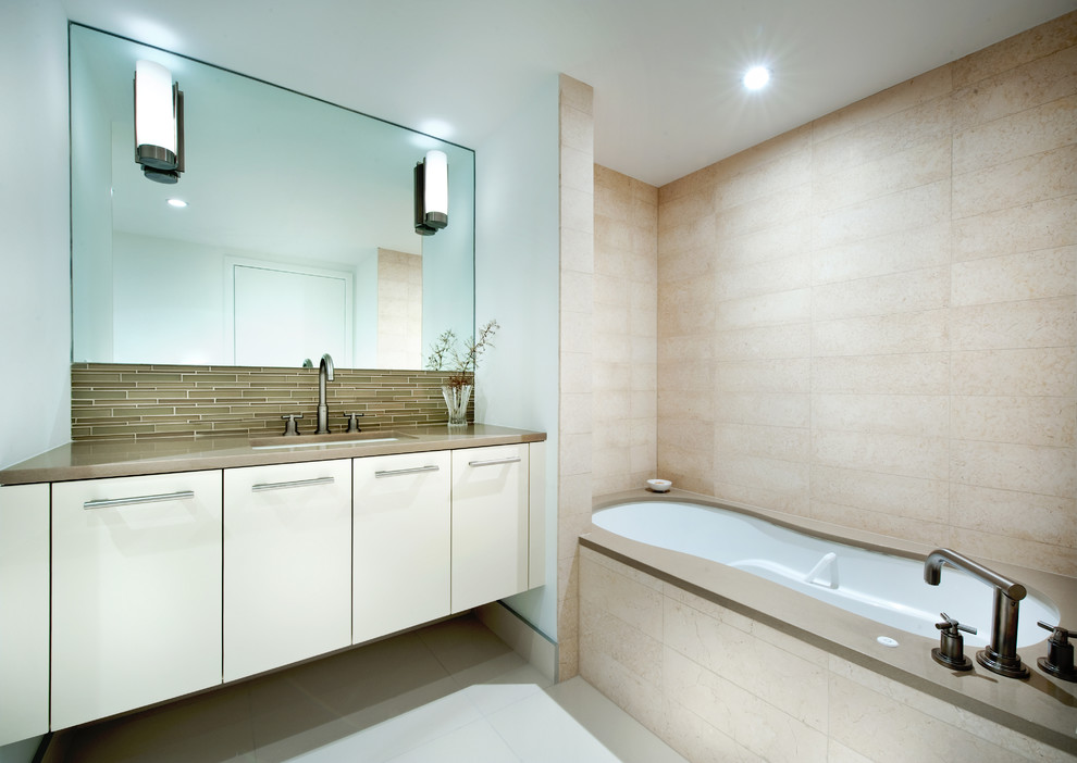 Example of a mid-sized minimalist master beige tile and stone tile limestone floor bathroom design in Miami with an undermount sink, flat-panel cabinets, beige cabinets, quartzite countertops, a one-piece toilet and white walls
