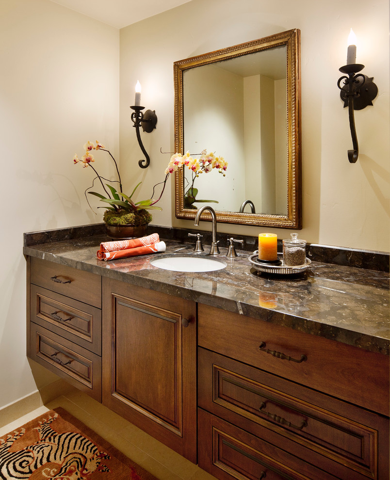 Elegant 3/4 limestone floor bathroom photo in Santa Barbara with an undermount sink, raised-panel cabinets, dark wood cabinets, granite countertops and beige walls
