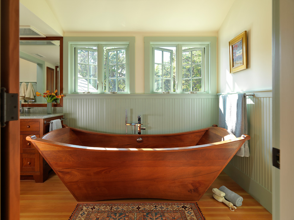 Inspiration for a craftsman master medium tone wood floor and brown floor freestanding bathtub remodel in Boston with recessed-panel cabinets, medium tone wood cabinets and beige walls