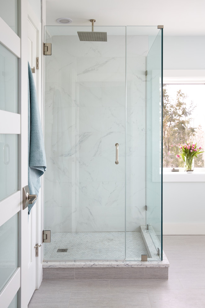 Design ideas for a medium sized coastal ensuite bathroom in Portland Maine with a corner shower, a one-piece toilet, grey tiles, porcelain tiles, blue walls, mosaic tile flooring, a vessel sink, grey floors and a hinged door.