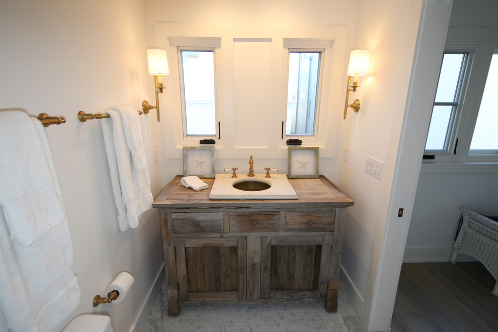 Example of a mid-sized classic marble floor bathroom design in Orange County with a drop-in sink, shaker cabinets, distressed cabinets and wood countertops