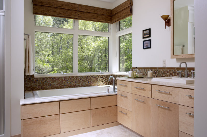 Medium sized contemporary ensuite bathroom in Boston with flat-panel cabinets, light wood cabinets, brown tiles, mosaic tiles, white walls, ceramic flooring, a built-in sink, engineered stone worktops, a built-in bath and beige floors.