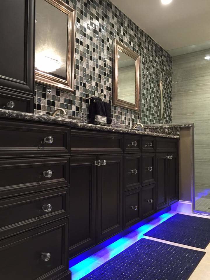 Medium sized contemporary ensuite bathroom in Miami with recessed-panel cabinets, a corner shower, a two-piece toilet, beige tiles, black tiles, grey tiles, beige walls, ceramic flooring, a submerged sink, engineered stone worktops, dark wood cabinets and mosaic tiles.