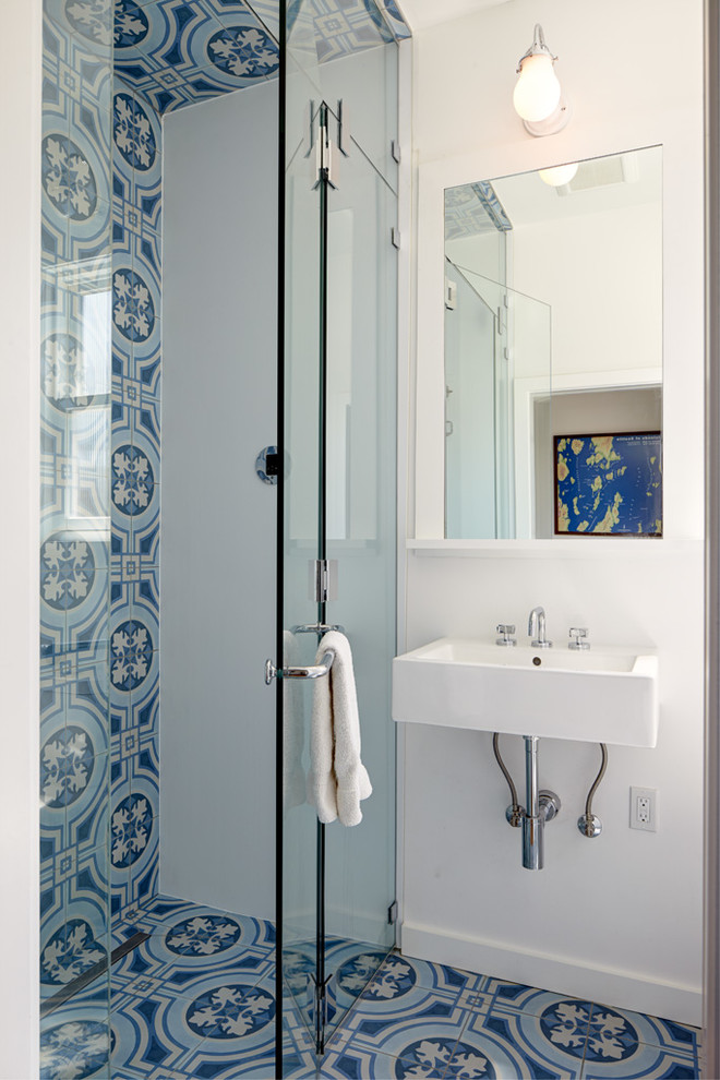 Example of an eclectic cement tile floor walk-in shower design in Seattle with white walls, a wall-mount sink and a hinged shower door