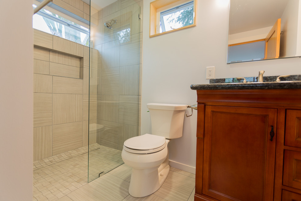 This is an example of a small contemporary shower room bathroom in Seattle with a submerged sink, beaded cabinets, medium wood cabinets, engineered stone worktops, a built-in shower, a one-piece toilet, beige tiles, ceramic tiles, white walls and ceramic flooring.