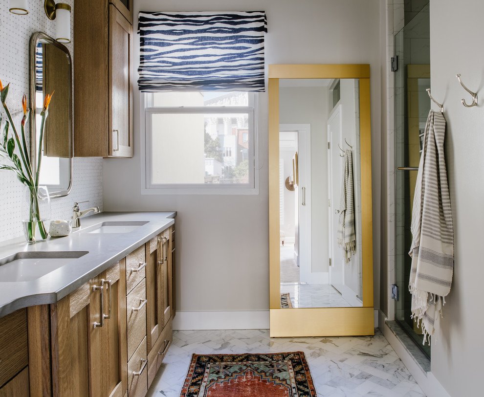 Example of a mid-sized eclectic master white tile and marble tile marble floor and white floor corner shower design in Austin with shaker cabinets, light wood cabinets, a two-piece toilet, gray walls, an undermount sink, quartz countertops and a hinged shower door