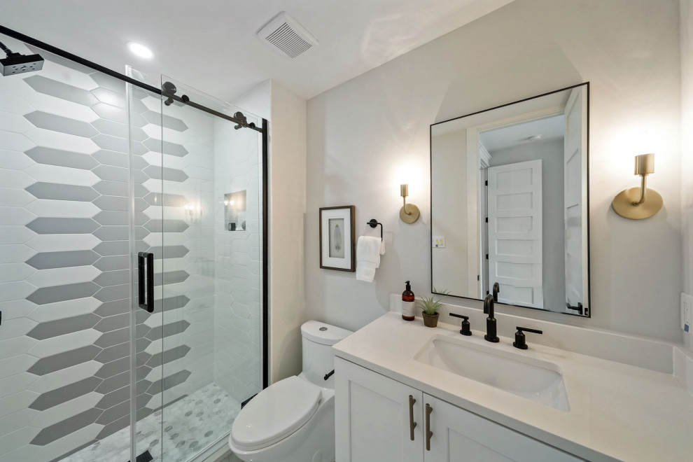 Bathroom - small contemporary kids' white tile single-sink bathroom idea in DC Metro with shaker cabinets, white cabinets, a one-piece toilet, an undermount sink, solid surface countertops, white countertops, a niche and a freestanding vanity