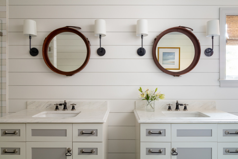Example of a mid-sized beach style master beige tile and porcelain tile porcelain tile and gray floor corner shower design in Boston with furniture-like cabinets, gray cabinets, a one-piece toilet, white walls, an undermount sink, marble countertops, a hinged shower door and multicolored countertops