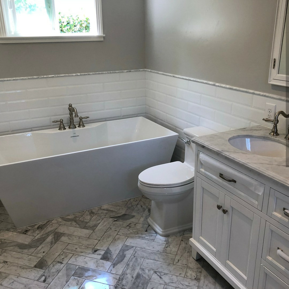 Traditional bathroom in Sacramento with shaker cabinets, white cabinets, a one-piece toilet, white tiles, ceramic tiles, grey walls, marble flooring, marble worktops, grey floors and white worktops.