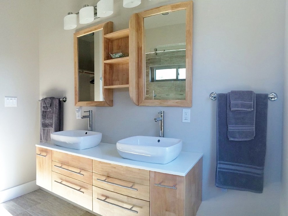 Example of a small urban master white tile and ceramic tile ceramic tile bathroom design in Denver with a vessel sink, flat-panel cabinets, light wood cabinets, solid surface countertops and beige walls