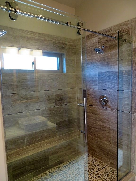 Small urban master white tile and ceramic tile ceramic tile double shower photo in Denver with a vessel sink, flat-panel cabinets, light wood cabinets, solid surface countertops and beige walls