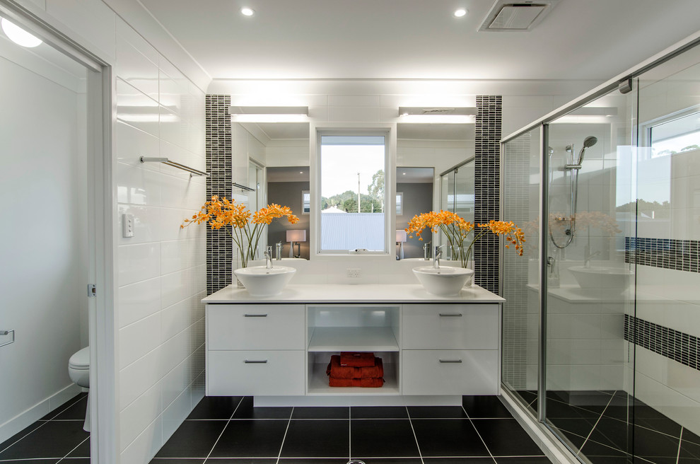 Photo of a medium sized contemporary ensuite bathroom in Brisbane with white cabinets, quartz worktops, an alcove shower, white tiles, ceramic tiles, white walls, ceramic flooring, a vessel sink and flat-panel cabinets.