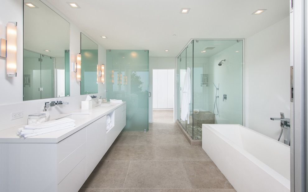 Inspiration for a mid-sized 1960s master limestone floor and beige floor corner shower remodel in Los Angeles with flat-panel cabinets, white cabinets, white walls, an undermount sink, solid surface countertops and a hinged shower door