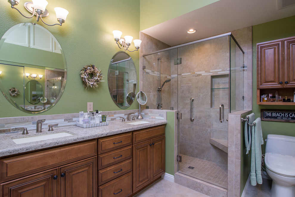Mid-sized beach style master beige tile and stone slab terra-cotta tile bathroom photo in San Diego with a drop-in sink, recessed-panel cabinets, medium tone wood cabinets, granite countertops, a one-piece toilet and green walls