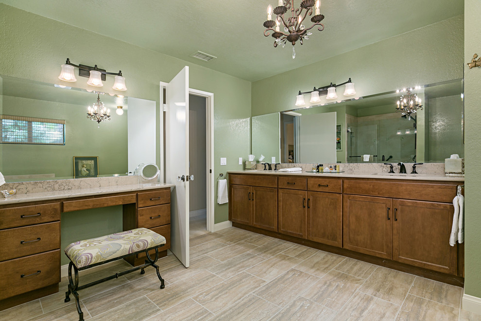 Bathroom - large traditional master black tile and travertine tile porcelain tile and brown floor bathroom idea in San Diego with recessed-panel cabinets, dark wood cabinets, a two-piece toilet, green walls, an undermount sink, granite countertops and a hinged shower door