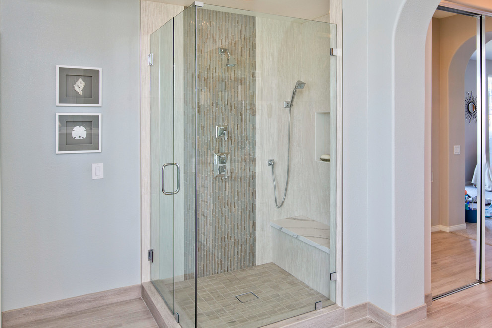 Photo of a large coastal ensuite bathroom in Tampa with shaker cabinets, white cabinets, a freestanding bath, a corner shower, a two-piece toilet, brown tiles, porcelain tiles, blue walls, porcelain flooring, a submerged sink and engineered stone worktops.