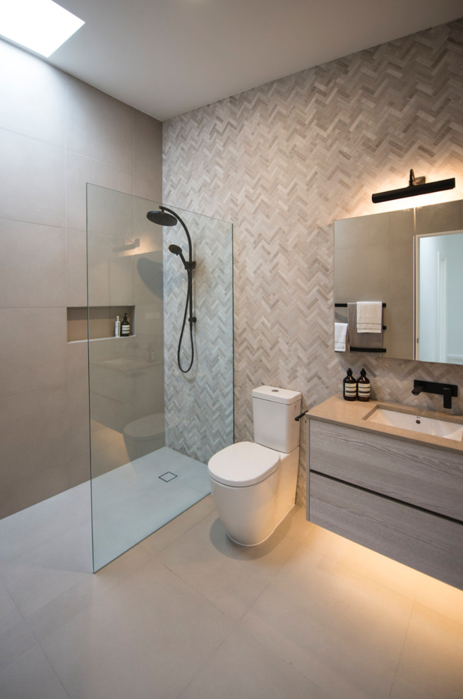 Inspiration for a small contemporary ensuite bathroom in Melbourne with light wood cabinets, a walk-in shower, multi-coloured tiles, mosaic tiles, grey walls, porcelain flooring, a submerged sink, engineered stone worktops, grey floors, an open shower, grey worktops and a two-piece toilet.