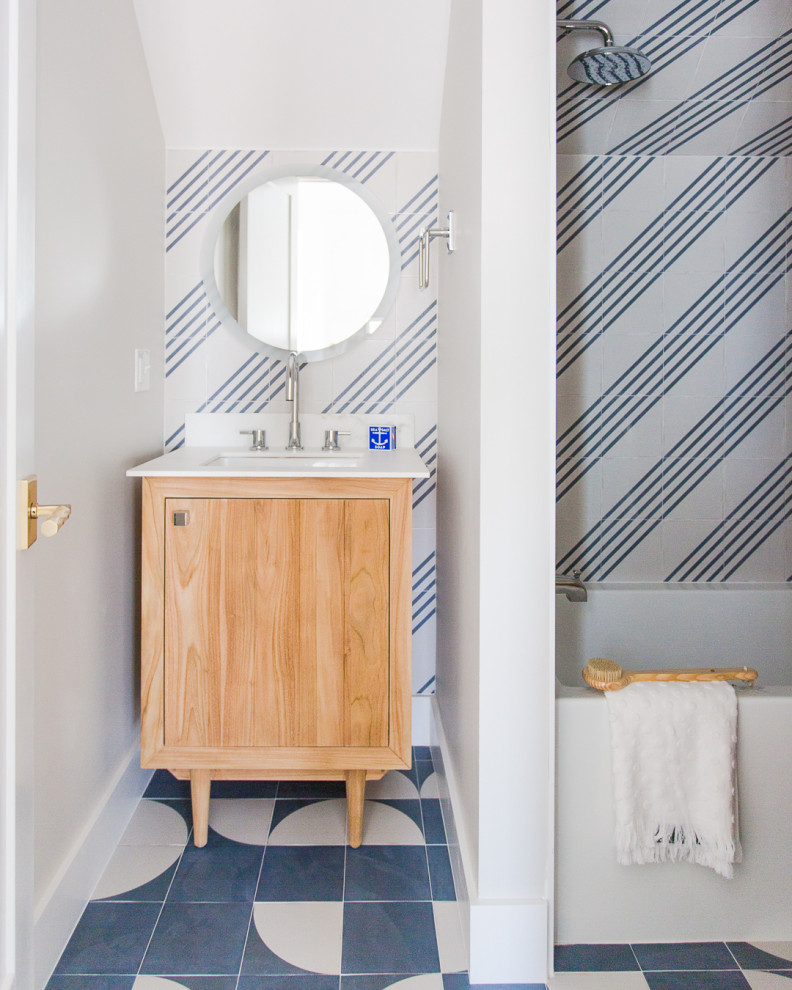 Idée de décoration pour une salle de bain marine en bois brun avec un placard à porte plane, une baignoire en alcôve, un combiné douche/baignoire, un carrelage bleu, un carrelage blanc, un mur gris, un lavabo encastré, un sol bleu, un plan de toilette blanc, meuble simple vasque et meuble-lavabo sur pied.