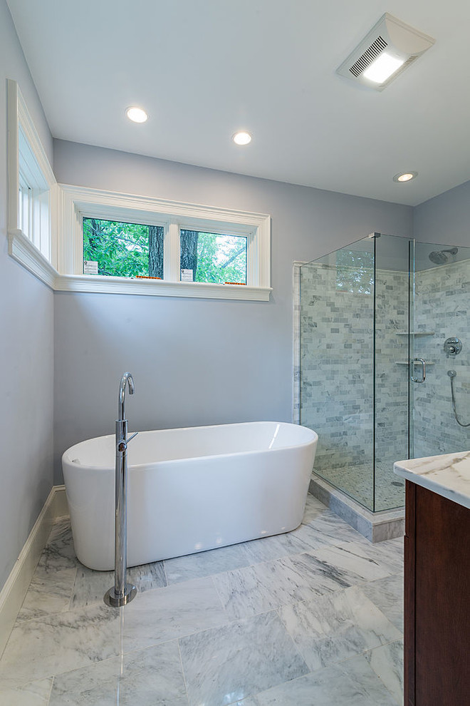 Photo of a medium sized traditional ensuite bathroom in Boston with dark wood cabinets, a freestanding bath, an alcove shower, grey tiles, multi-coloured tiles, white tiles, blue walls, marble flooring, a submerged sink, marble worktops, marble tiles, multi-coloured floors and a hinged door.