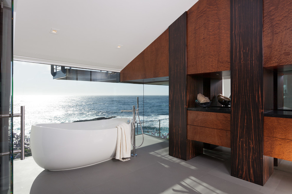 Example of a large minimalist master freestanding bathtub design in San Francisco with flat-panel cabinets and medium tone wood cabinets