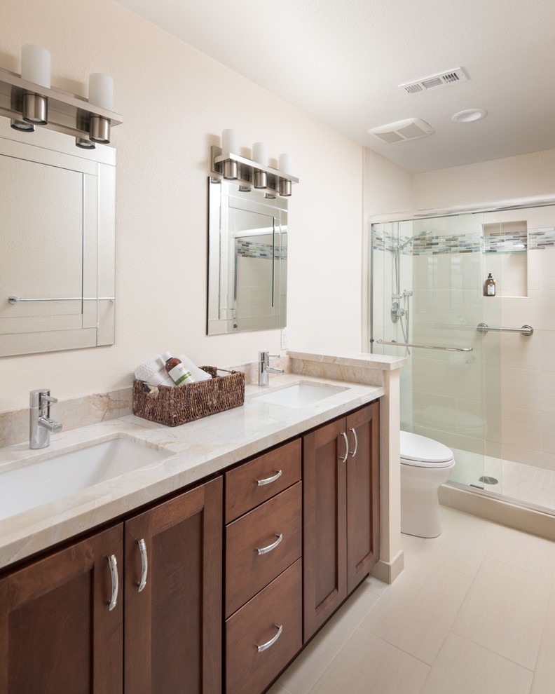 Alcove shower - mid-sized modern 3/4 beige tile and porcelain tile porcelain tile alcove shower idea in San Diego with flat-panel cabinets, medium tone wood cabinets, a two-piece toilet, beige walls, an undermount sink and granite countertops