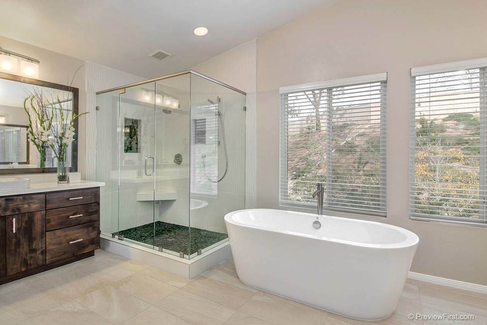 Example of a large transitional master beige tile and stone slab porcelain tile bathroom design in San Diego with flat-panel cabinets, dark wood cabinets, a one-piece toilet, beige walls, an integrated sink and quartz countertops