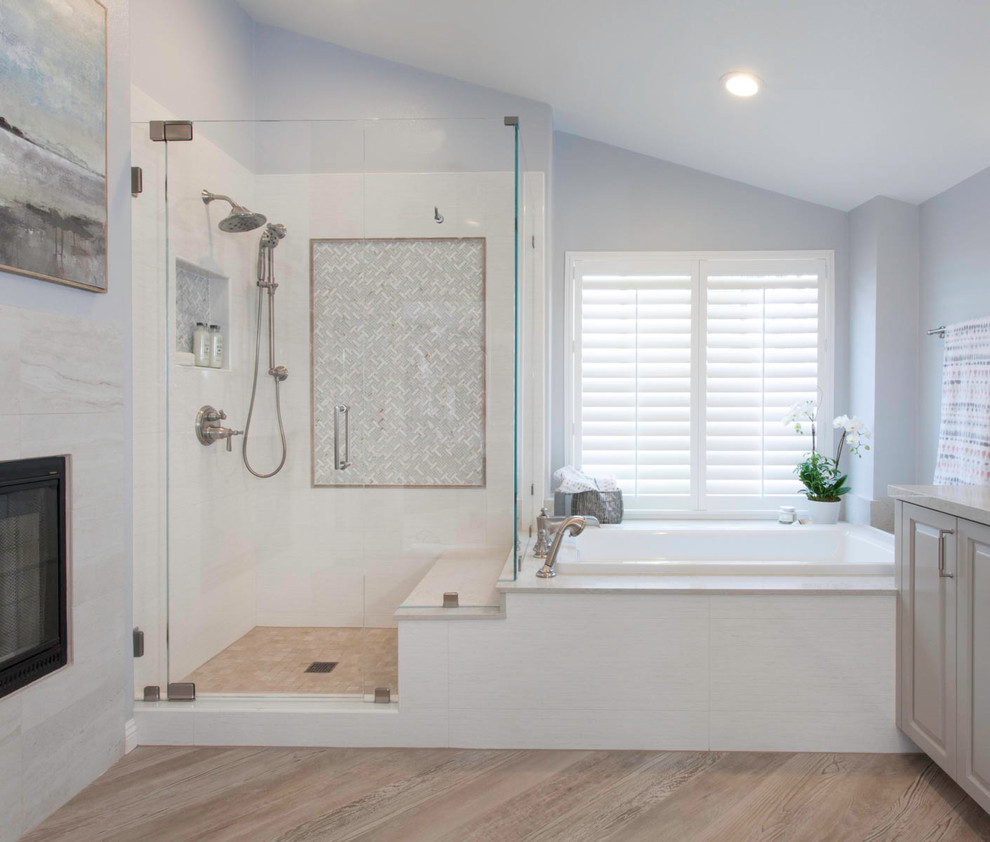 Inspiration for a large transitional master white tile and porcelain tile porcelain tile and beige floor bathroom remodel in San Diego with raised-panel cabinets, gray cabinets, a one-piece toilet, gray walls, an undermount sink, quartz countertops, a hinged shower door and gray countertops