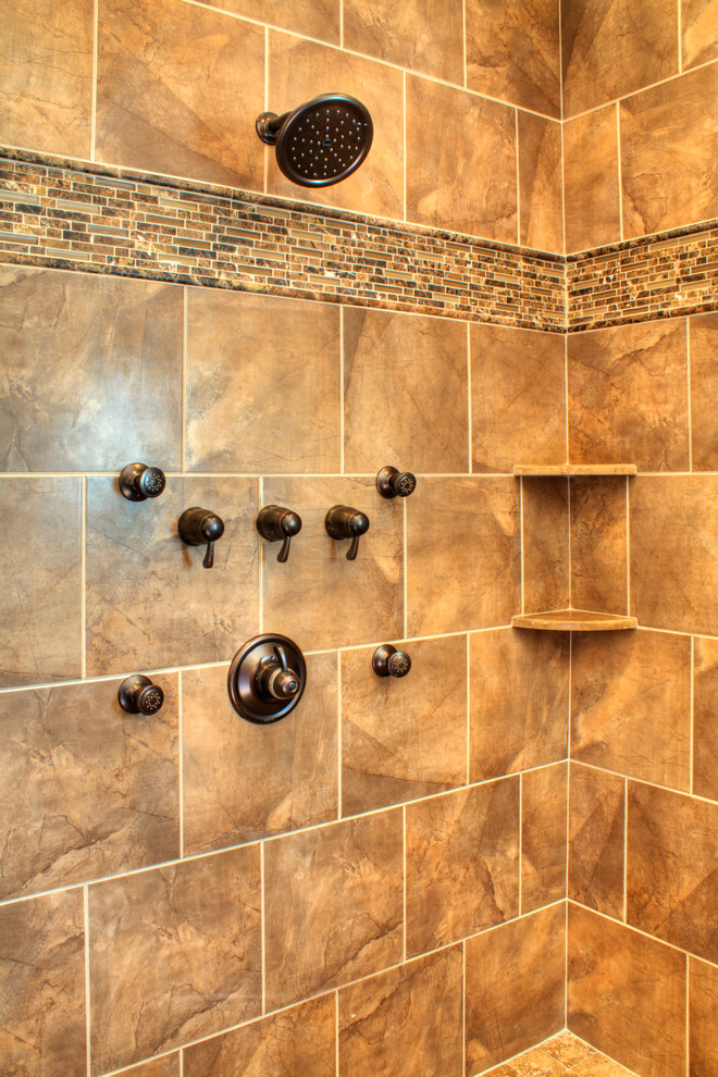 Example of a huge classic master brown tile and porcelain tile porcelain tile bathroom design in Other with raised-panel cabinets, dark wood cabinets, granite countertops, a two-piece toilet, an undermount sink and brown walls