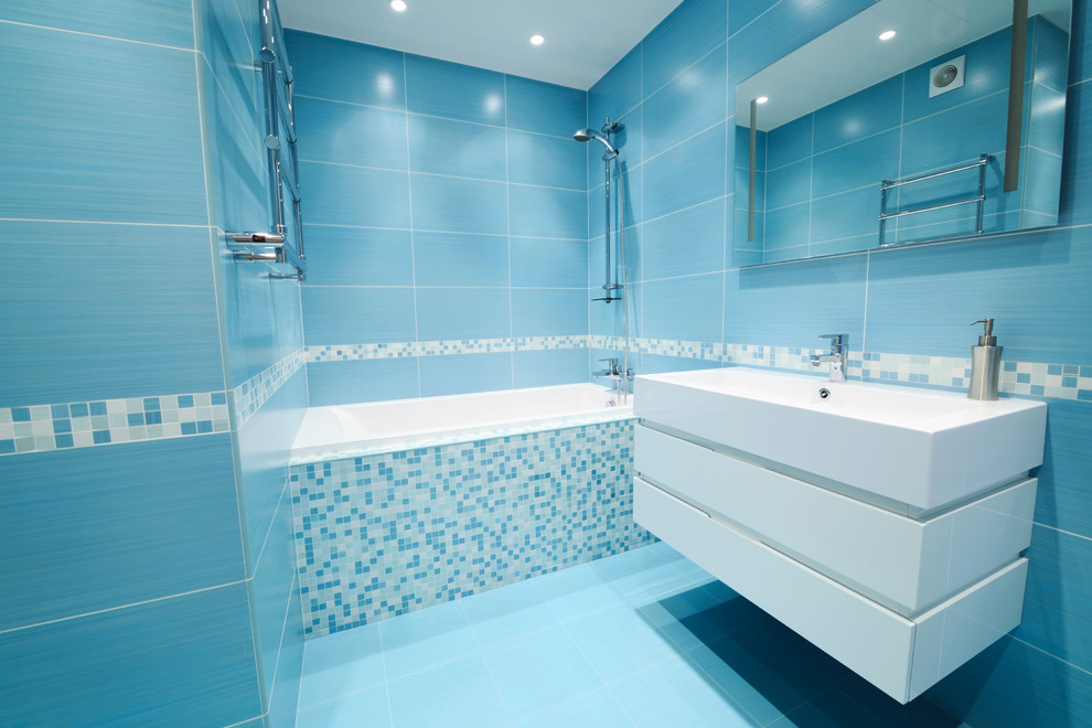 Photo of a medium sized victorian shower room bathroom in Other with freestanding cabinets, white cabinets, a claw-foot bath, a one-piece toilet, white tiles, ceramic tiles, white walls, ceramic flooring, a built-in sink, solid surface worktops and white floors.