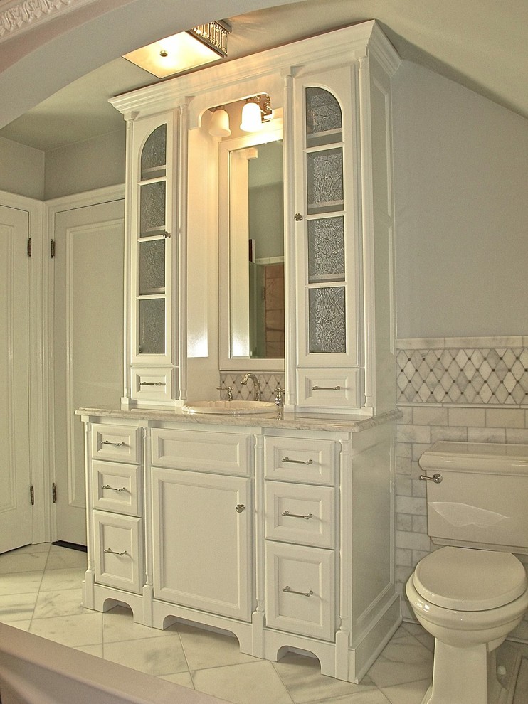 Inspiration for a small contemporary master white tile and subway tile ceramic tile and white floor bathroom remodel in Milwaukee with a drop-in sink, flat-panel cabinets, white cabinets, marble countertops, a one-piece toilet, gray walls and white countertops