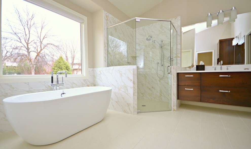 Design ideas for a medium sized contemporary ensuite bathroom in Boise with a wall-mounted sink, flat-panel cabinets, dark wood cabinets, quartz worktops, a freestanding bath, a corner shower, white tiles, porcelain tiles, beige walls and porcelain flooring.