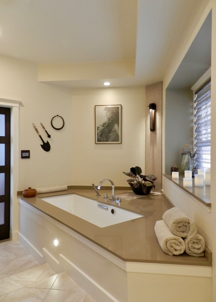 Example of a mid-sized asian master beige tile and porcelain tile porcelain tile wet room design in Boston with an undermount tub, beige walls and solid surface countertops