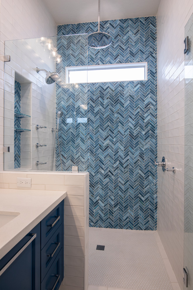 Example of a mid-sized trendy master blue tile and glass tile porcelain tile and white floor doorless shower design in Phoenix with shaker cabinets, blue cabinets, a two-piece toilet, blue walls, an undermount sink, quartz countertops, a hinged shower door and white countertops