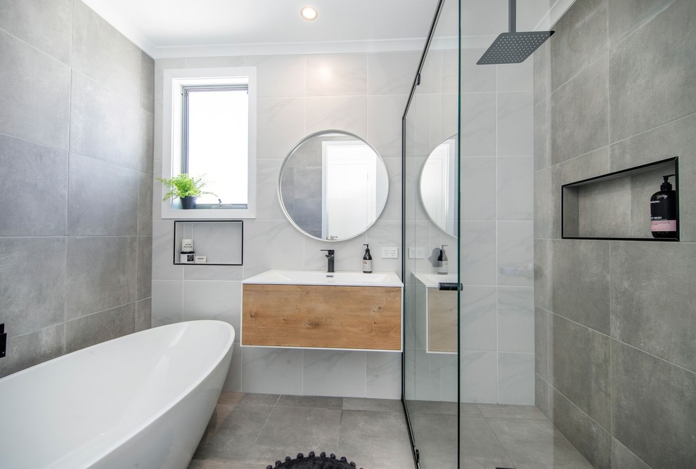 Small kids' white tile and ceramic tile ceramic tile and gray floor bathroom photo in Other with recessed-panel cabinets, light wood cabinets, white walls, an integrated sink, solid surface countertops, a hinged shower door and white countertops