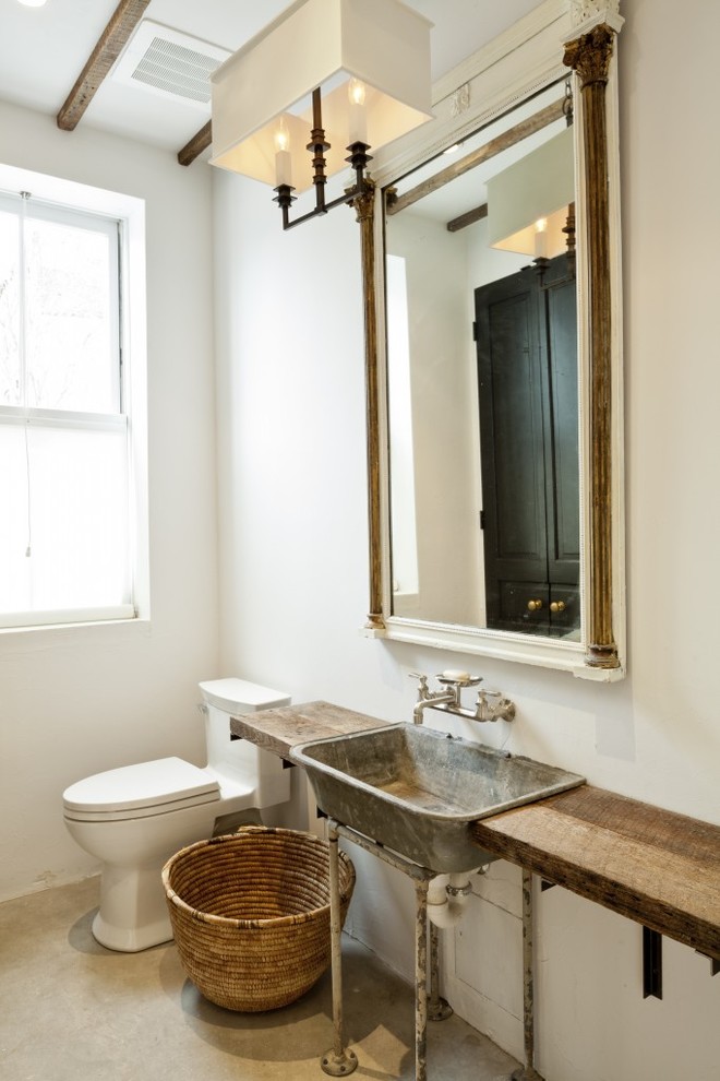 Bathroom - mid-sized industrial 3/4 concrete floor bathroom idea in DC Metro with a two-piece toilet, white walls, a trough sink and wood countertops