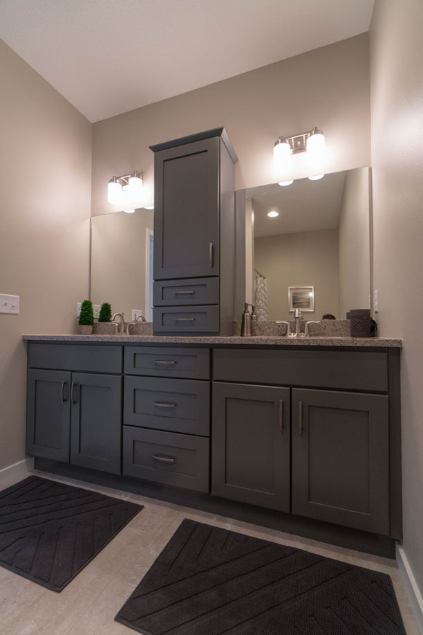 Inspiration for a mid-sized modern master gray tile porcelain tile and gray floor doorless shower remodel in Cedar Rapids with shaker cabinets, medium tone wood cabinets, a one-piece toilet, gray walls, an undermount sink and quartzite countertops