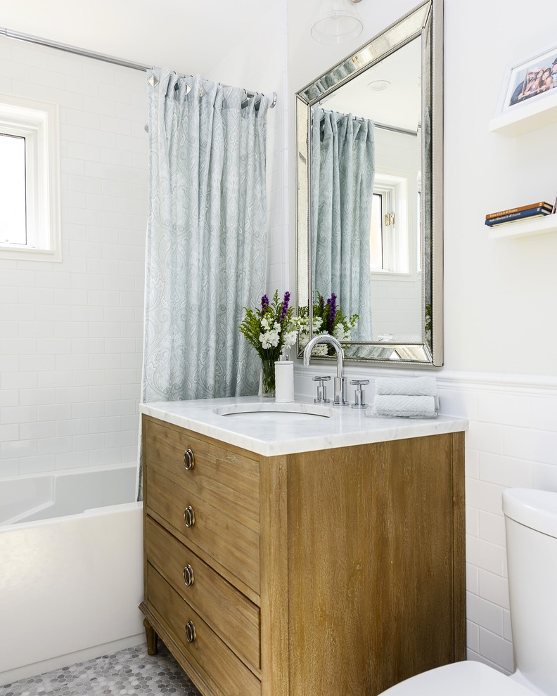 This is an example of a medium sized traditional ensuite bathroom in Montreal with a submerged sink, flat-panel cabinets, medium wood cabinets, an alcove bath, a shower/bath combination, a two-piece toilet, white tiles, white walls and a shower curtain.