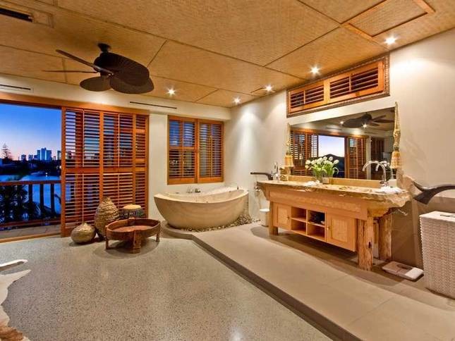 Esempio di una grande stanza da bagno padronale tropicale con vasca freestanding, doccia aperta, pavimento in cemento e doccia aperta
