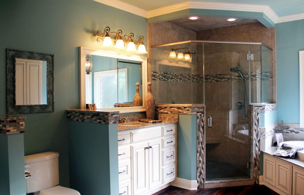 Example of a large transitional master bathroom design in New Orleans with an undermount sink, raised-panel cabinets and blue walls