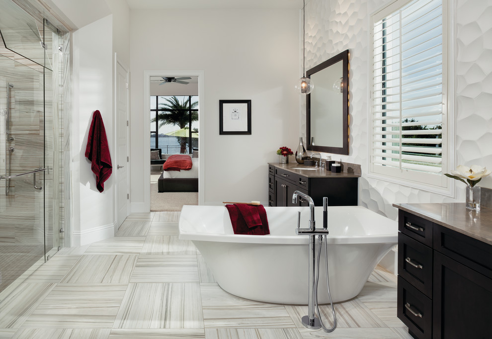 Exemple d'une douche en alcôve chic en bois foncé avec un lavabo encastré, un placard à porte shaker, une baignoire indépendante, un carrelage blanc et un mur blanc.