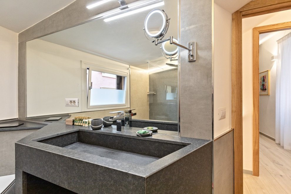 Inspiration for a large contemporary ensuite bathroom in Rome with open cabinets, grey cabinets, a double shower, a wall mounted toilet, grey tiles, porcelain tiles, grey walls, porcelain flooring, a console sink, granite worktops, grey floors, a sliding door, grey worktops, a single sink, a freestanding vanity unit and a drop ceiling.