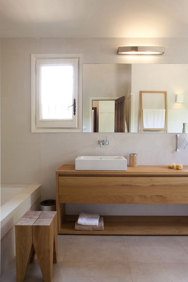 Design ideas for a large scandinavian ensuite bathroom in Barcelona with flat-panel cabinets, medium wood cabinets, an alcove bath, a shower/bath combination, ceramic flooring, a vessel sink and wooden worktops.